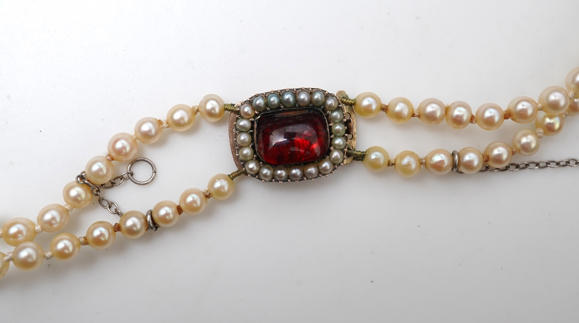 A cultured pearl and garnet necklace, 19th century and later